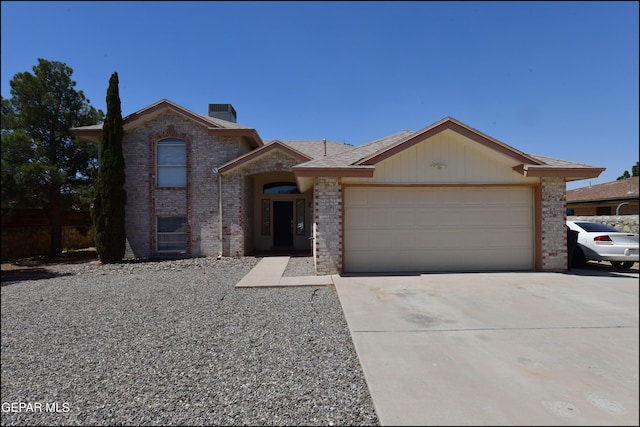 view of front facade featuring driveway, brick siding, and an attached garage