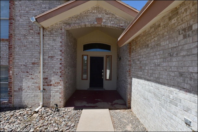 property entrance with brick siding
