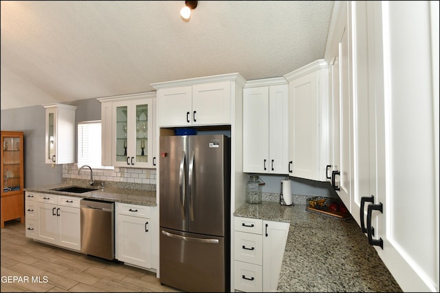 kitchen with white cabinetry, appliances with stainless steel finishes, and a sink