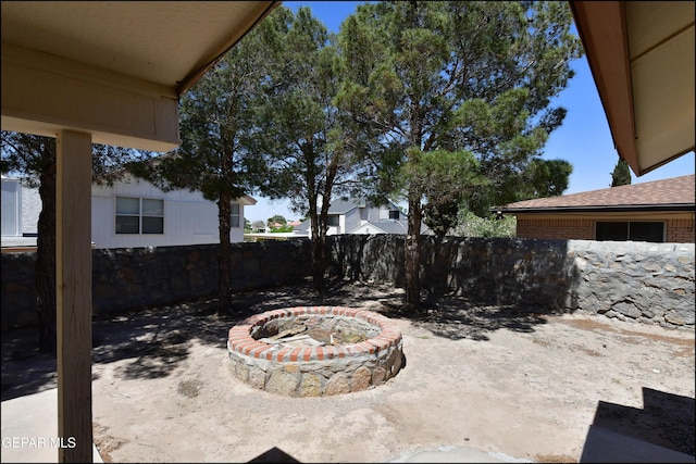 view of yard featuring a fire pit and fence