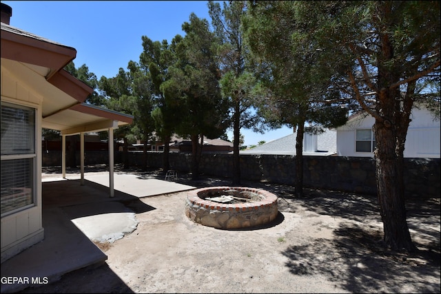 view of patio with an outdoor fire pit and a fenced backyard