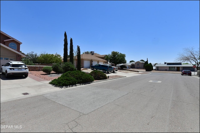 view of street featuring a residential view, curbs, and sidewalks