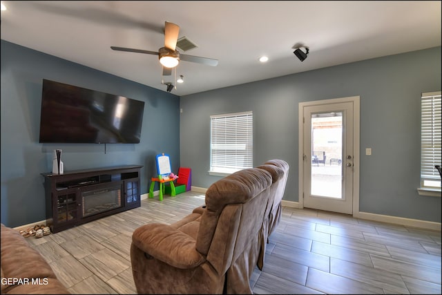 living room with baseboards, ceiling fan, recessed lighting, and wood finish floors