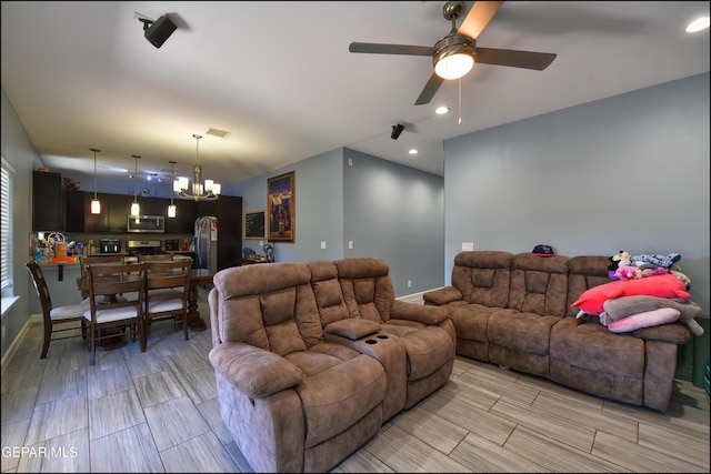 living room with a chandelier, ceiling fan, and recessed lighting