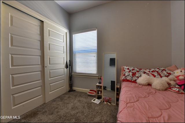 bedroom with carpet, baseboards, and a closet