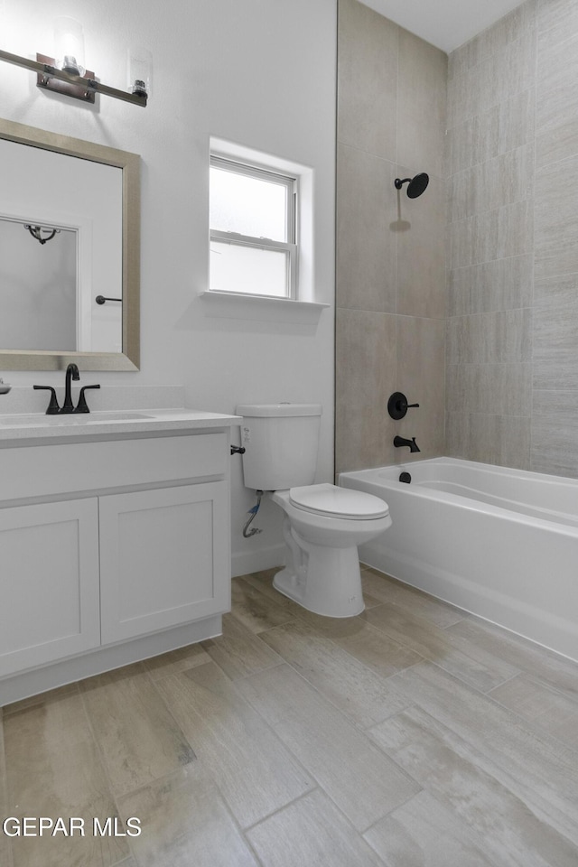 bathroom with toilet, shower / tub combination, and vanity