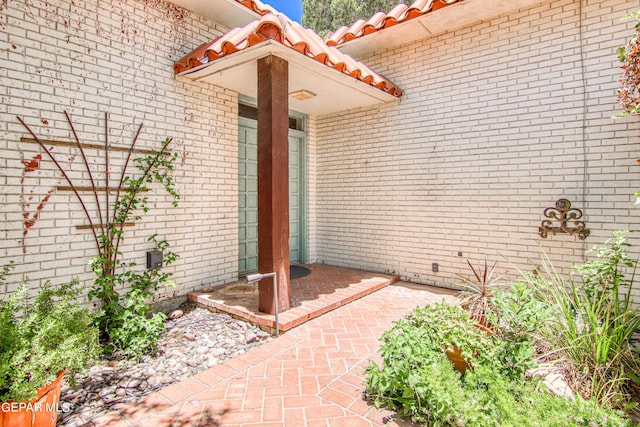 6041 Torrey Pines Dr, El Paso, TX 79912 - view of exterior entry with brick siding and a tiled roof