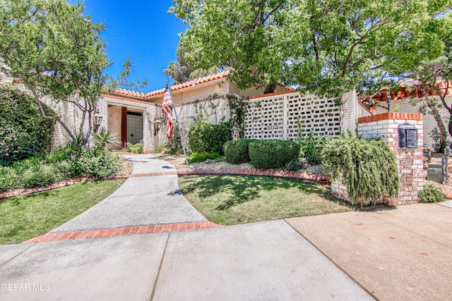 6041 Torrey Pines Dr, El Paso, TX 79912 - mediterranean / spanish-style home with a tiled roof and a front lawn