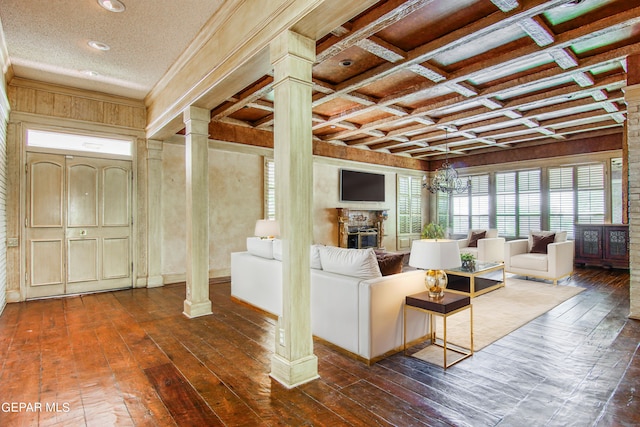 6041 Torrey Pines Dr, El Paso, TX 79912 - living area featuring dark wood-type flooring, decorative columns, and a fireplace