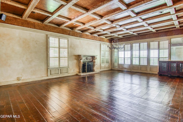 6041 Torrey Pines Dr, El Paso, TX 79912 - unfurnished living room featuring an inviting chandelier, coffered ceiling, wood-type flooring, a fireplace with raised hearth, and beam ceiling