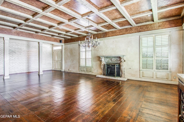 6041 Torrey Pines Dr, El Paso, TX 79912 - unfurnished living room featuring beamed ceiling, coffered ceiling, a high end fireplace, wood-type flooring, and an inviting chandelier
