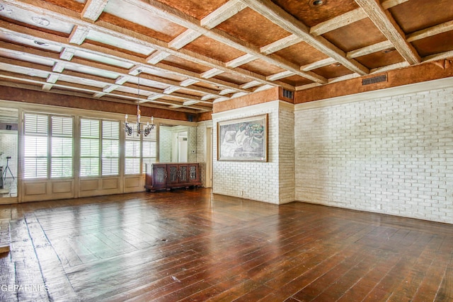 6041 Torrey Pines Dr, El Paso, TX 79912 - spare room with coffered ceiling, brick wall, a chandelier, hardwood / wood-style floors, and visible vents