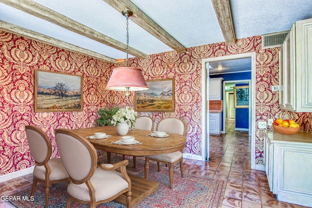 6041 Torrey Pines Dr, El Paso, TX 79912 - dining area with beam ceiling, visible vents, baseboards, a textured ceiling, and wallpapered walls