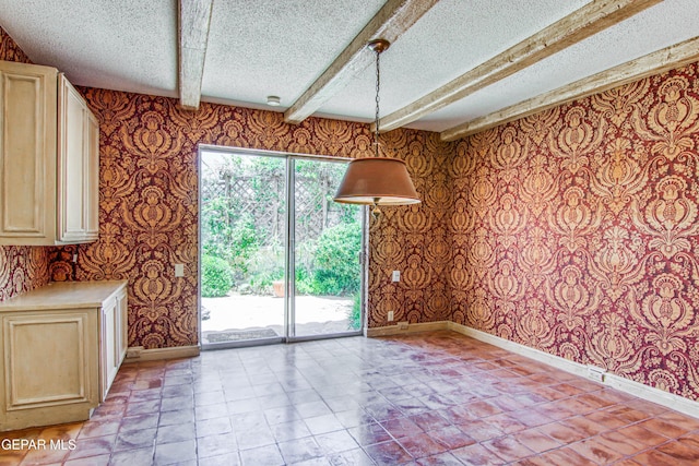 6041 Torrey Pines Dr, El Paso, TX 79912 - unfurnished dining area with baseboards, wallpapered walls, and a textured ceiling