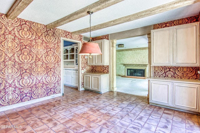 6041 Torrey Pines Dr, El Paso, TX 79912 - kitchen featuring beamed ceiling, a large fireplace, wallpapered walls, baseboards, and decorative light fixtures
