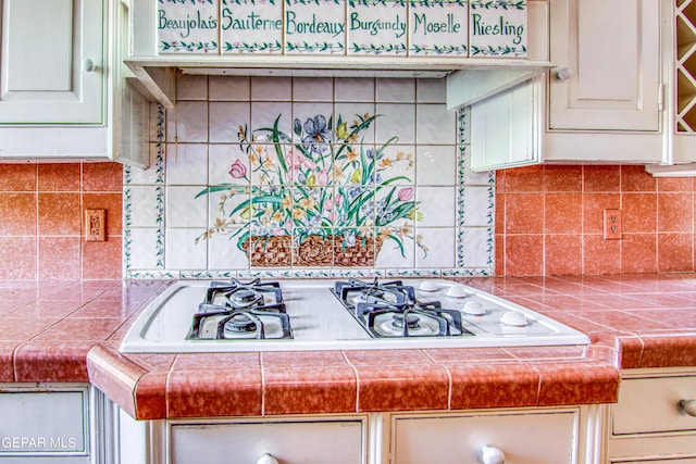 6041 Torrey Pines Dr, El Paso, TX 79912 - interior details featuring cream cabinetry, white gas cooktop, and backsplash