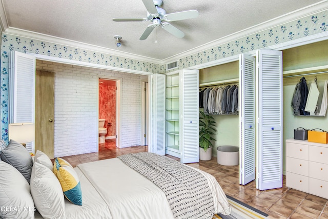 6041 Torrey Pines Dr, El Paso, TX 79912 - bedroom featuring a textured ceiling, multiple closets, crown molding, and wallpapered walls