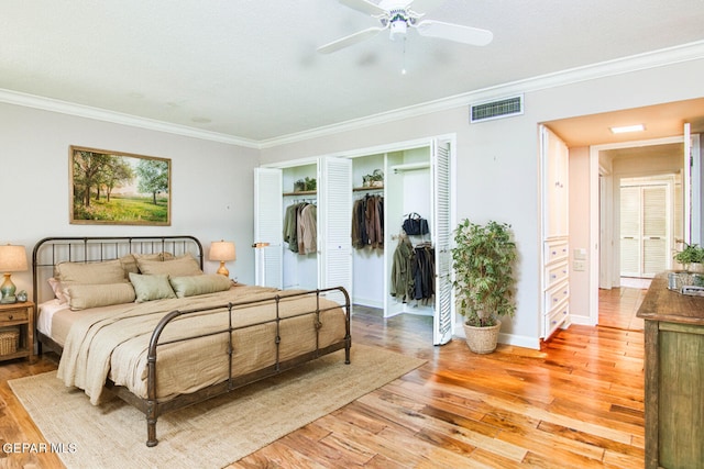 6041 Torrey Pines Dr, El Paso, TX 79912 - bedroom with visible vents, ornamental molding, a closet, and light wood-style flooring
