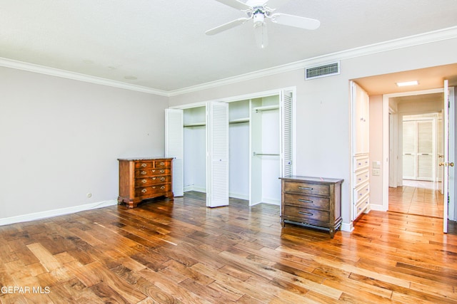 6041 Torrey Pines Dr, El Paso, TX 79912 - unfurnished bedroom featuring a closet, crown molding, visible vents, baseboards, and wood finished floors