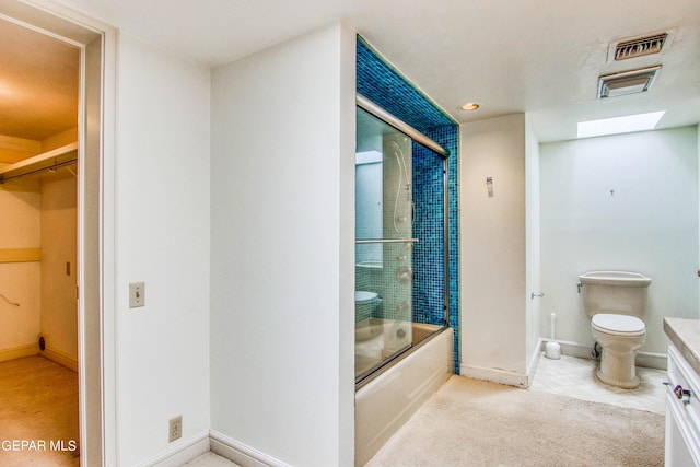 6041 Torrey Pines Dr, El Paso, TX 79912 - bathroom with combined bath / shower with glass door, toilet, vanity, baseboards, and visible vents