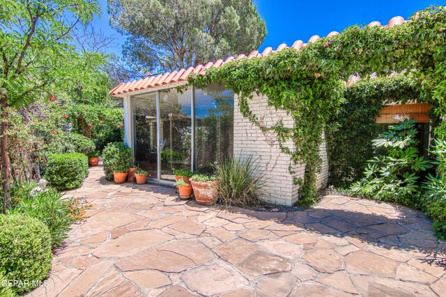 6041 Torrey Pines Dr, El Paso, TX 79912 - view of patio featuring fence and a sunroom