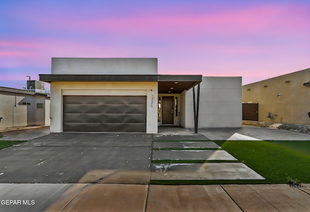 1725 Eased St, El Paso, TX 79928 - contemporary home with stucco siding, cooling unit, aphalt driveway, and a garage