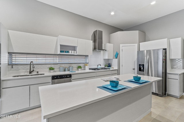 1725 Eased St, El Paso, TX 79928 - kitchen with a sink, backsplash, wall chimney range hood, white cabinets, and appliances with stainless steel finishes