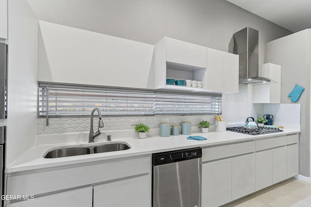 1725 Eased St, El Paso, TX 79928 - kitchen featuring decorative backsplash, a sink, stainless steel appliances, light countertops, and wall chimney exhaust hood