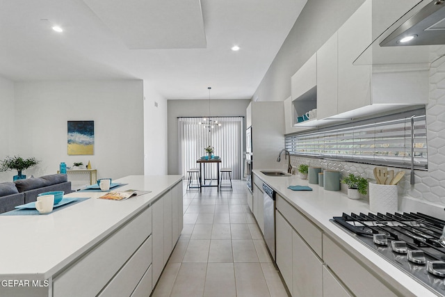 1725 Eased St, El Paso, TX 79928 - kitchen featuring a sink, stainless steel appliances, a notable chandelier, white cabinetry, and light countertops