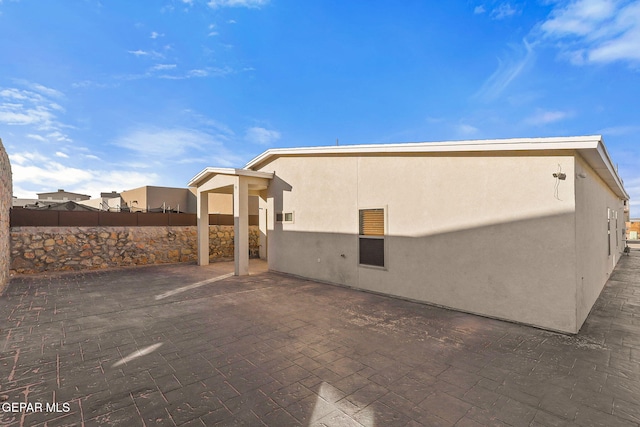 1725 Eased St, El Paso, TX 79928 - view of home's exterior featuring fence, a patio, and stucco siding