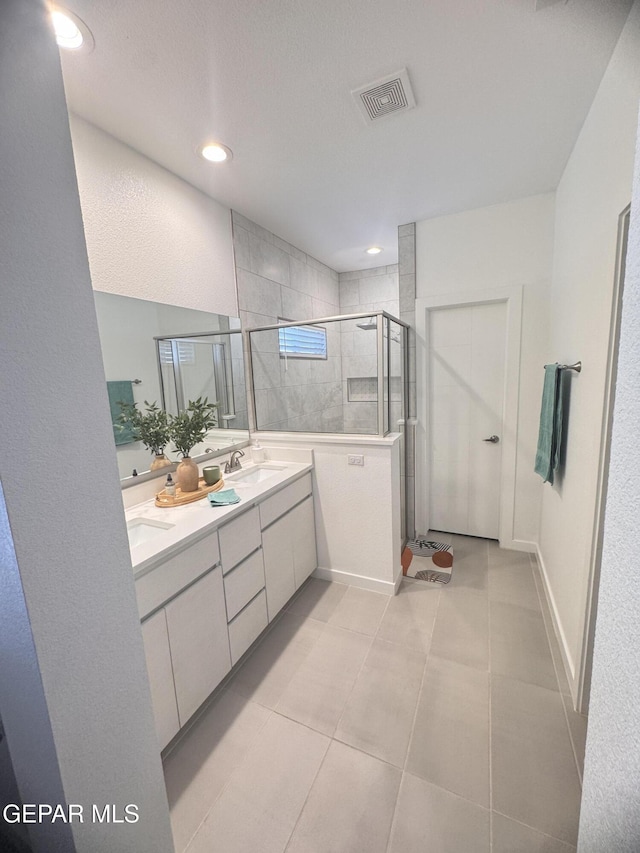 1725 Eased St, El Paso, TX 79928 - full bathroom featuring a shower stall, a sink, double vanity, visible vents, and tile patterned flooring