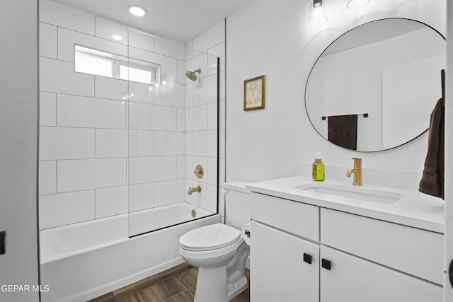 full bath featuring wood finished floors, toilet, bathing tub / shower combination, and vanity