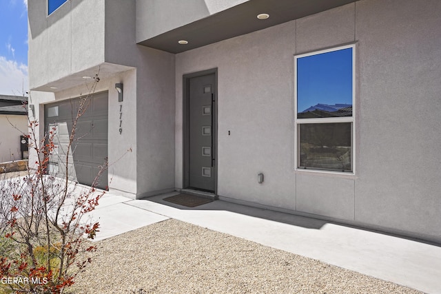 view of exterior entry featuring stucco siding