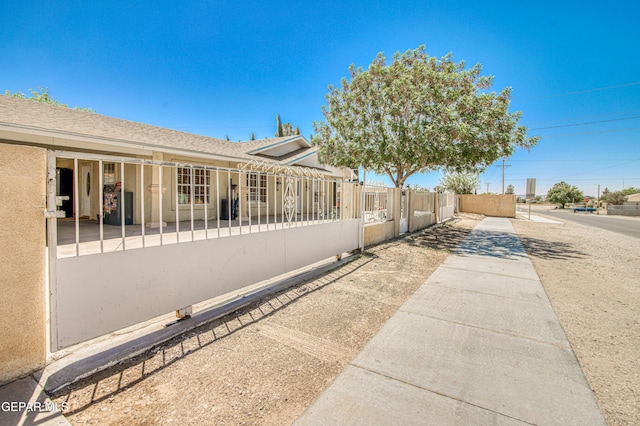 916 Mike Maros St, Fabens, TX 79838 - view of property exterior featuring stucco siding and a fenced front yard