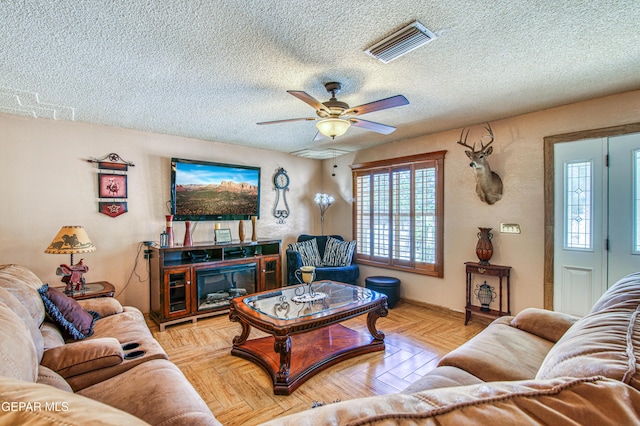 916 Mike Maros St, Fabens, TX 79838 - living area with a textured ceiling, visible vents, and a ceiling fan