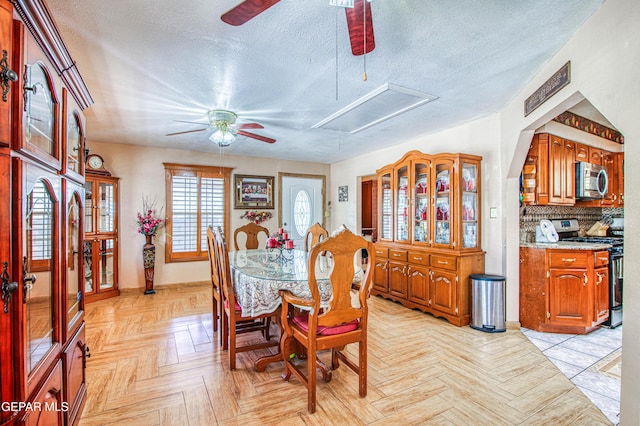 916 Mike Maros St, Fabens, TX 79838 - dining room featuring attic access, a textured ceiling, ceiling fan, and baseboards