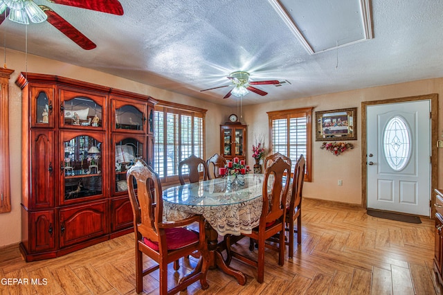 916 Mike Maros St, Fabens, TX 79838 - dining room featuring attic access, a ceiling fan, baseboards, and a textured ceiling