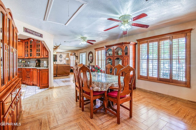 916 Mike Maros St, Fabens, TX 79838 - dining area with attic access, ceiling fan, and a textured ceiling
