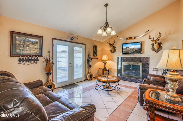 916 Mike Maros St, Fabens, TX 79838 - living room featuring a notable chandelier, vaulted ceiling, a high end fireplace, tile patterned flooring, and french doors