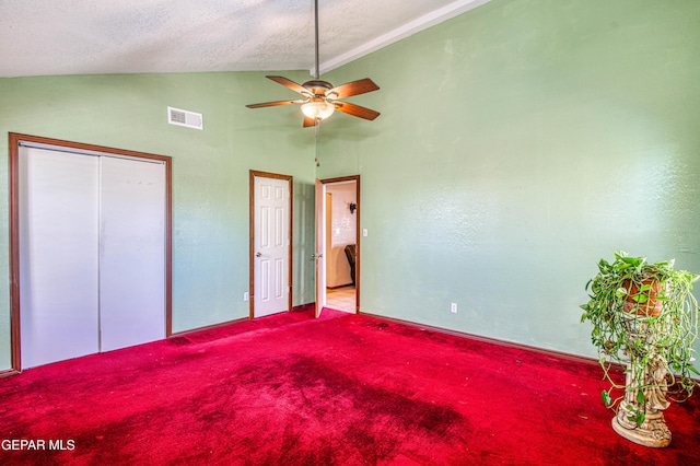 916 Mike Maros St, Fabens, TX 79838 - unfurnished bedroom with carpet floors, vaulted ceiling, ceiling fan, visible vents, and a textured ceiling