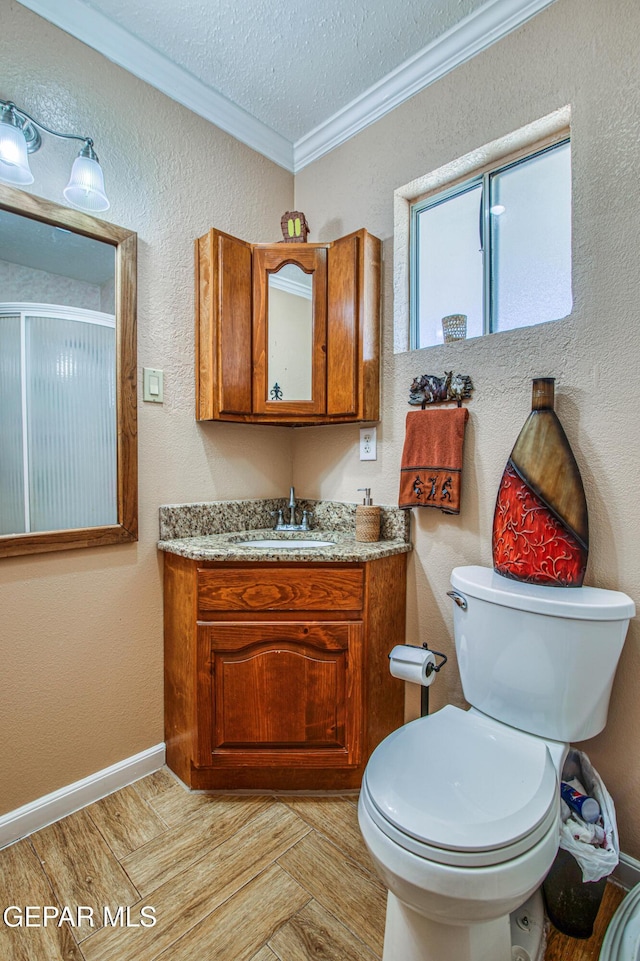 916 Mike Maros St, Fabens, TX 79838 - bathroom featuring a textured ceiling, vanity, toilet, and crown molding
