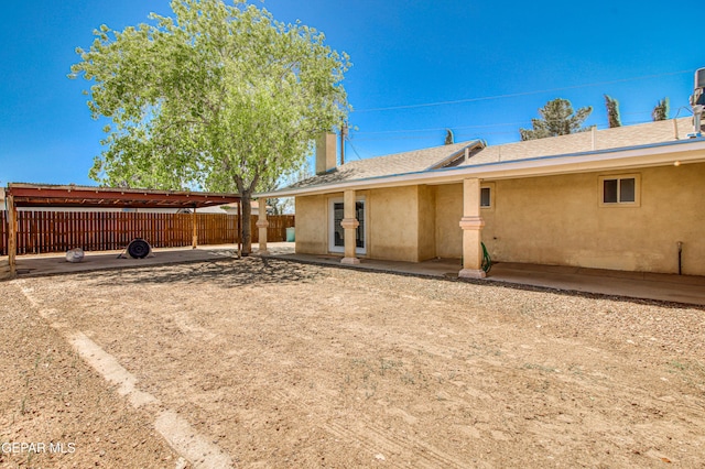 916 Mike Maros St, Fabens, TX 79838 - rear view of property with a shingled roof, stucco siding, and fence