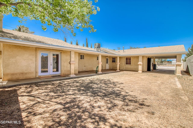 916 Mike Maros St, Fabens, TX 79838 - rear view of house featuring fence, french doors, and stucco siding