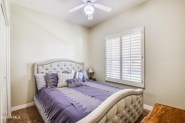 carpeted bedroom with a ceiling fan and baseboards
