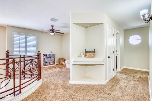 corridor with baseboards, an upstairs landing, carpet flooring, and visible vents
