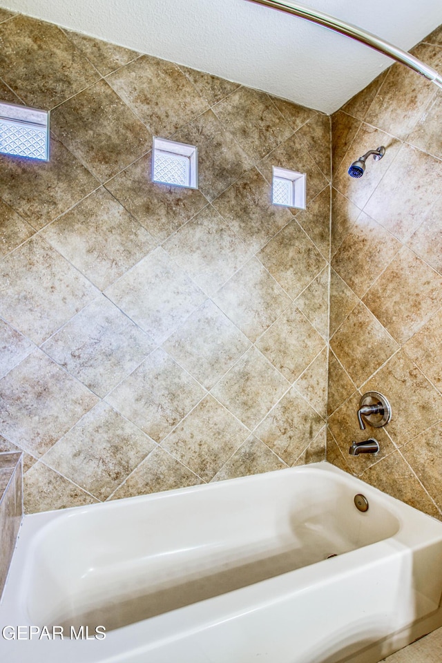 full bath featuring shower / tub combination and plenty of natural light