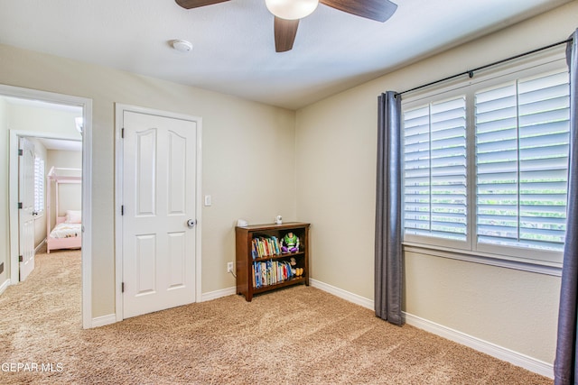 carpeted bedroom featuring baseboards and ceiling fan