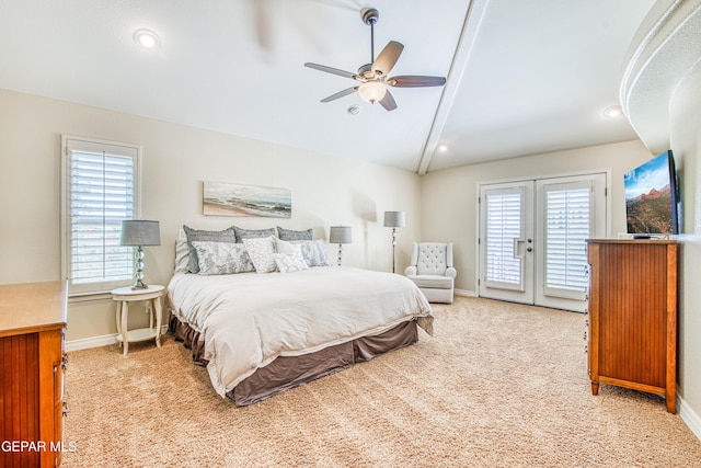 bedroom featuring light colored carpet, baseboards, vaulted ceiling, and access to exterior