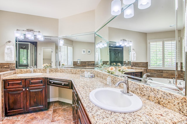 bathroom featuring double vanity, a sink, and a garden tub