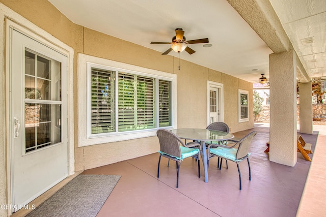view of patio with a ceiling fan and outdoor dining area